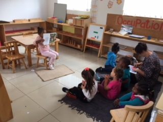 Children working on mats in the Montessori classroom