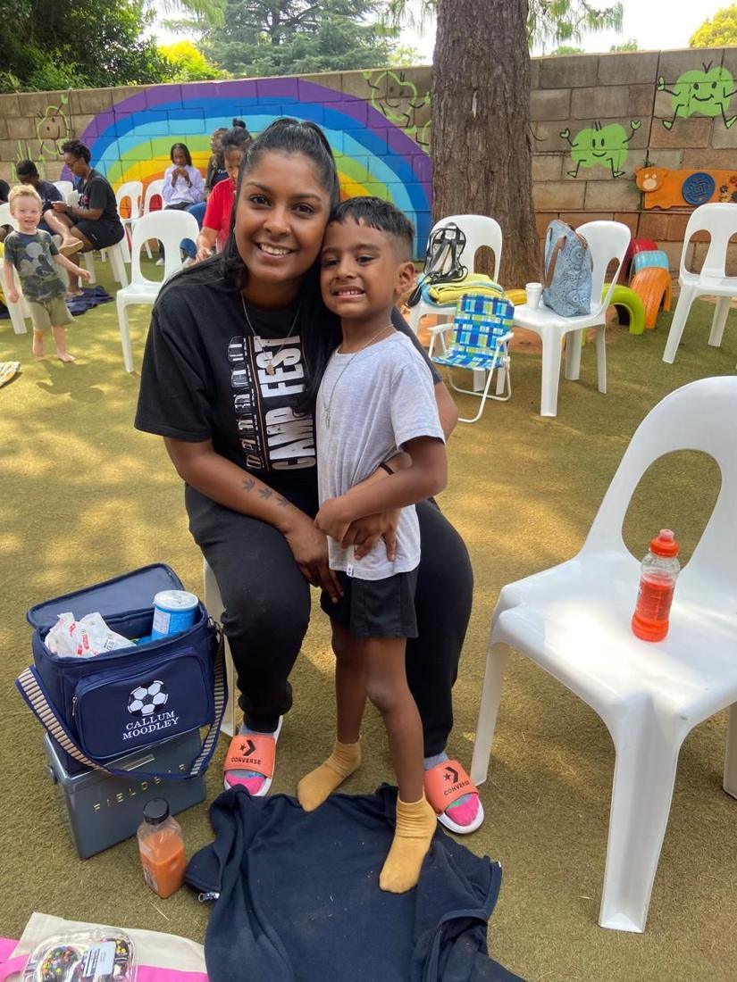 A mum hugging her son at a family day