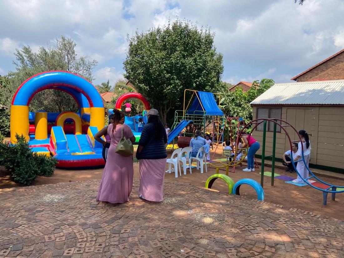 Families enjoying the playground and jumping castles